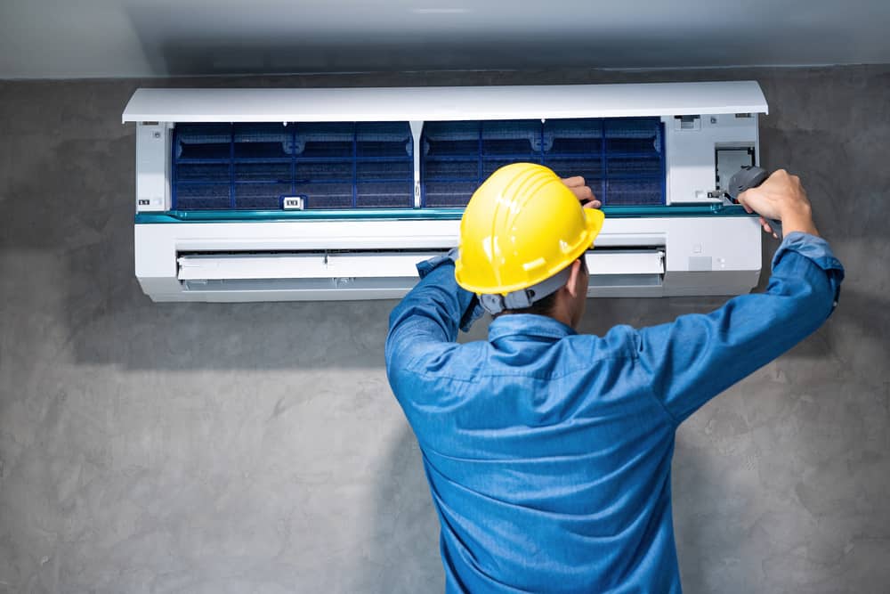 technician working on ac unit.