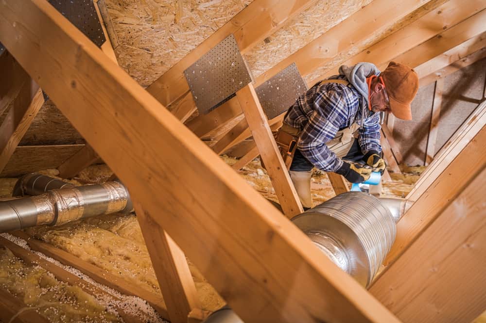 technician working in attic.