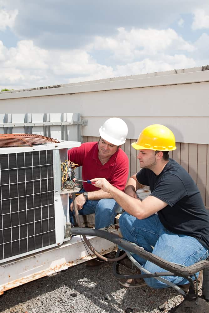 technicians working on ac unit.